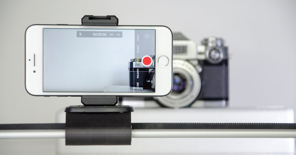 Smartphone recording setup beside a vintage camera